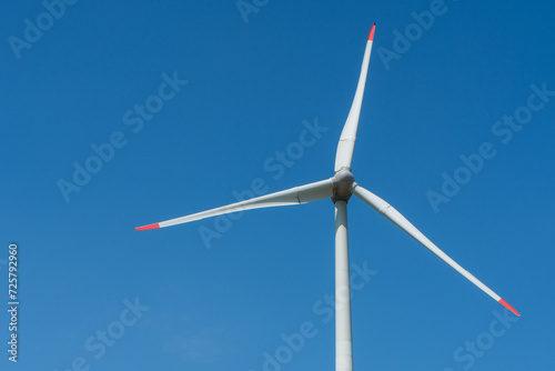 Wind turbine against blue sky with copy space