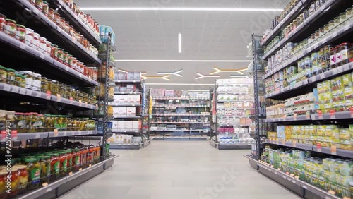 Rows of crowded foodstuffs in a supermarket photo
