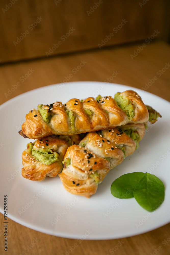 Turkish borek rolls with spinach and cheese on the white plate. A traditional Turkish pastry Turkish borek rolls with spinach and cheese on the white plate. A traditional Turkish pastry