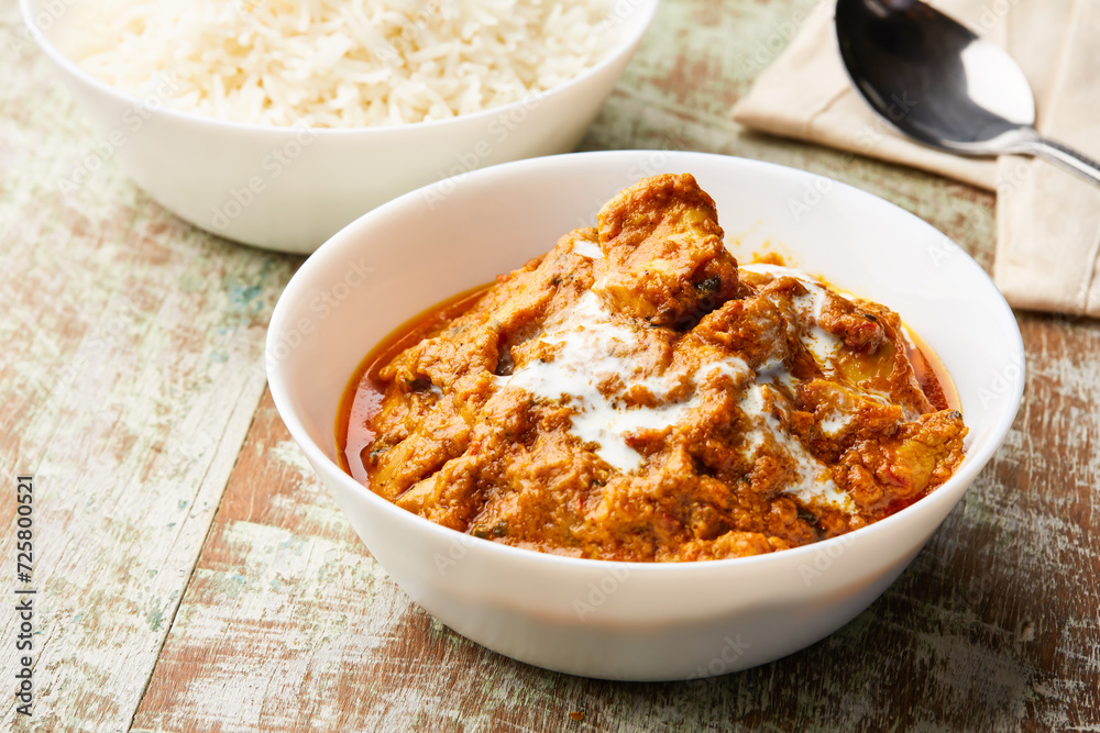 Spicy Butter Chicken makhani masala korma karahi with boiled rice served in dish isolated on table top view of arabic food Spicy Butter Chicken makhani masala korma karahi with boiled rice served in dish isolated on table top view of arabic food