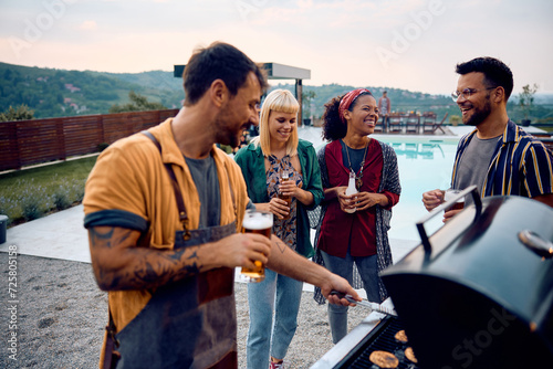 Multiracial group of happy friends having barbecue party by pool.