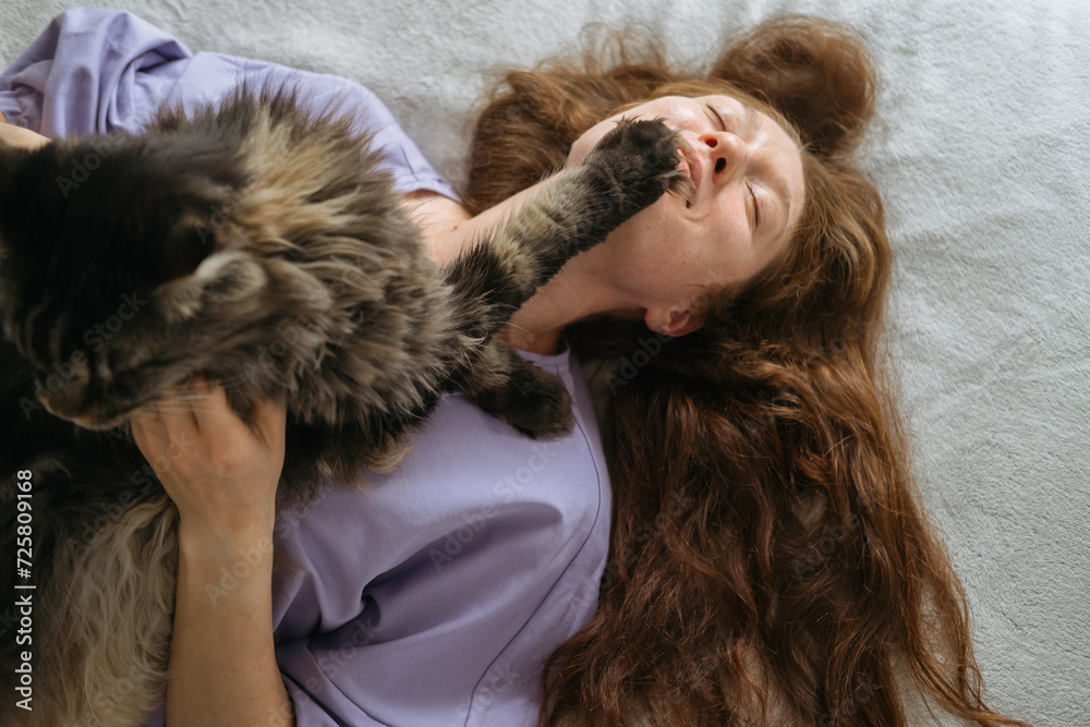 Joyful Woman Playing with Cat on Bed Joyful Woman Playing with Cat on Bed