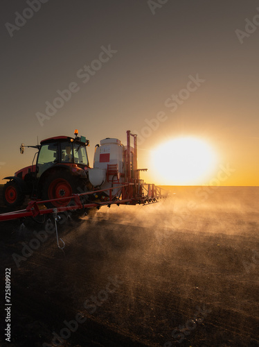 Tractor spraying soybean crops field