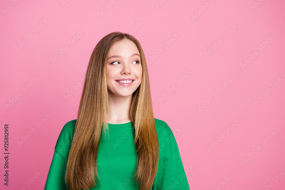 Fototapeta premium Portrait of blonde hair youth girl wearing green t shirt looking empty space dreaming about shopping isolated on pink color background