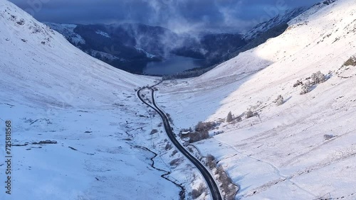 Snowy landscape and A591 road leading to Thirlmere lake, Lake District National Park, Cumbria, England photo