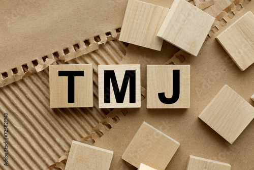 TMJ (Temporomandibular Joints) wooden blocks on craft background photo