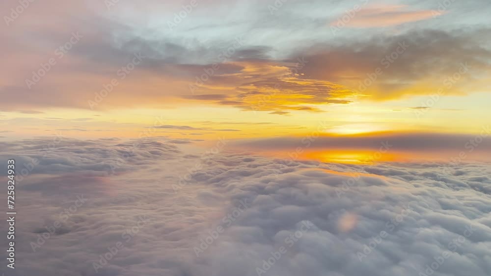Aerial view from the airplane cabin. Clouds. Sunrise. Aerial view from the airplane cabin. Clouds. Sunrise.