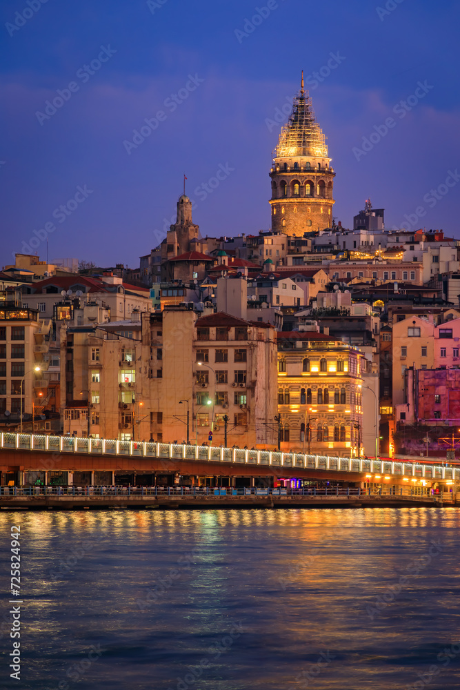 Obraz premium Sunrise cityscape of the Karakoy area across the Bosphorus Strait near Galata Bridge with the Galata Tower at the blue hour in Istanbul, Turkey
