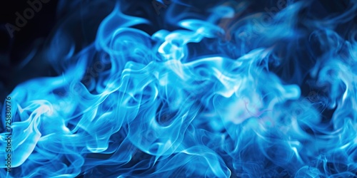 Blue smoke captured in a close-up shot against a black background. Perfect for adding a touch of mystery and elegance to your design projects