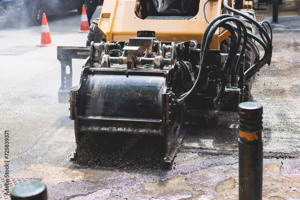 Process of asphalting, blacktopping and paving, asphalt paver machine and steam roller compactor during construction and repairing works, workers on the construction site, rental vehicle working