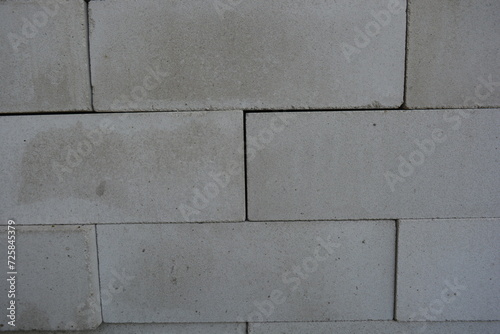 Building materials, new white bricks laid out densely and beautifully. Background of building, cement, white bricks.