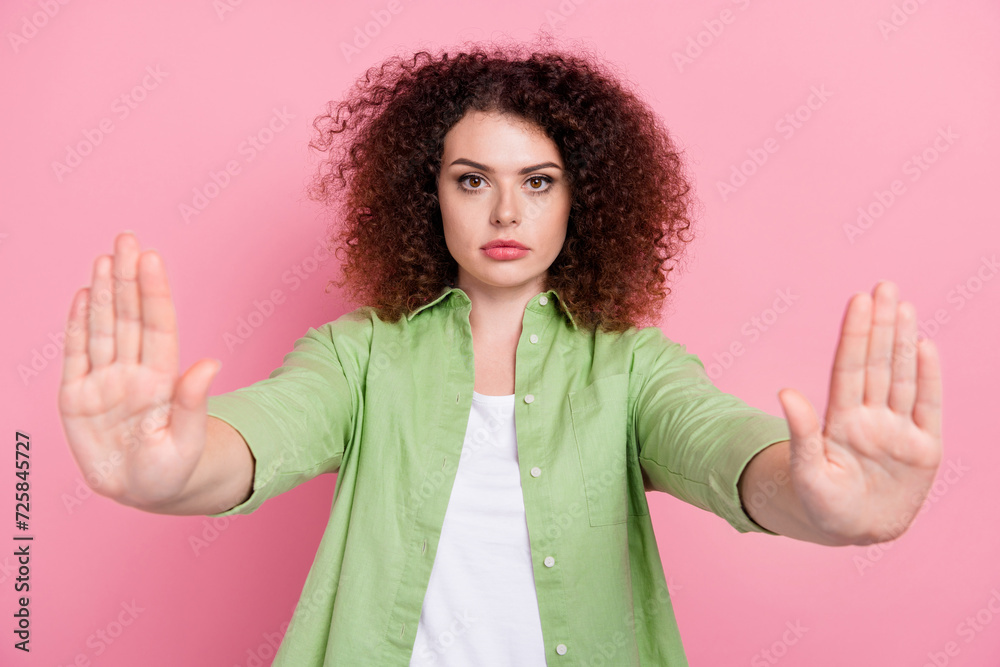 Photo portrait of lovely young lady stretch hands stop gesture symbol wear trendy green garment isolated on pink color background Photo portrait of lovely young lady stretch hands stop gesture symbol wear trendy green garment isolated on pink color background