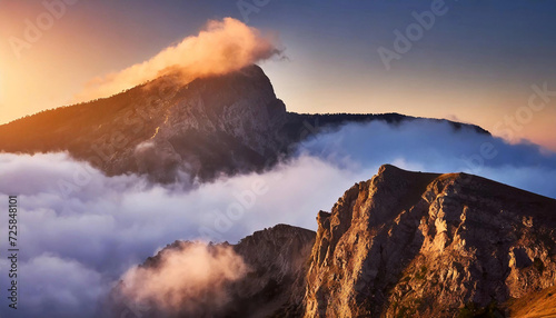 Serene mountain peaks veiled in a mystical blend of clouds and fog, basking in the warm glow of a captivating sunrise. An alluring travel setting.
