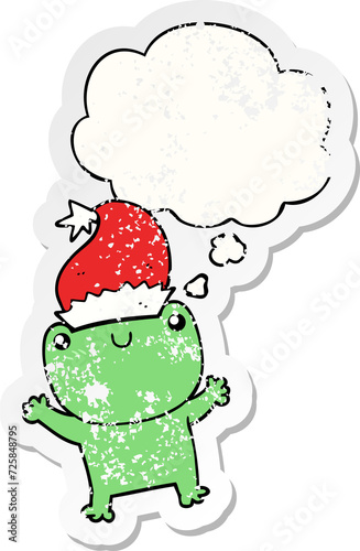 cute cartoon frog wearing christmas hat and thought bubble as a distressed worn sticker