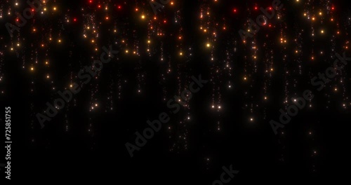 An orange curtain of sparkling lights. Red, orange, yellow, white particles with tails of scattered small particles falling down on a black background. Seamless looping animation. photo