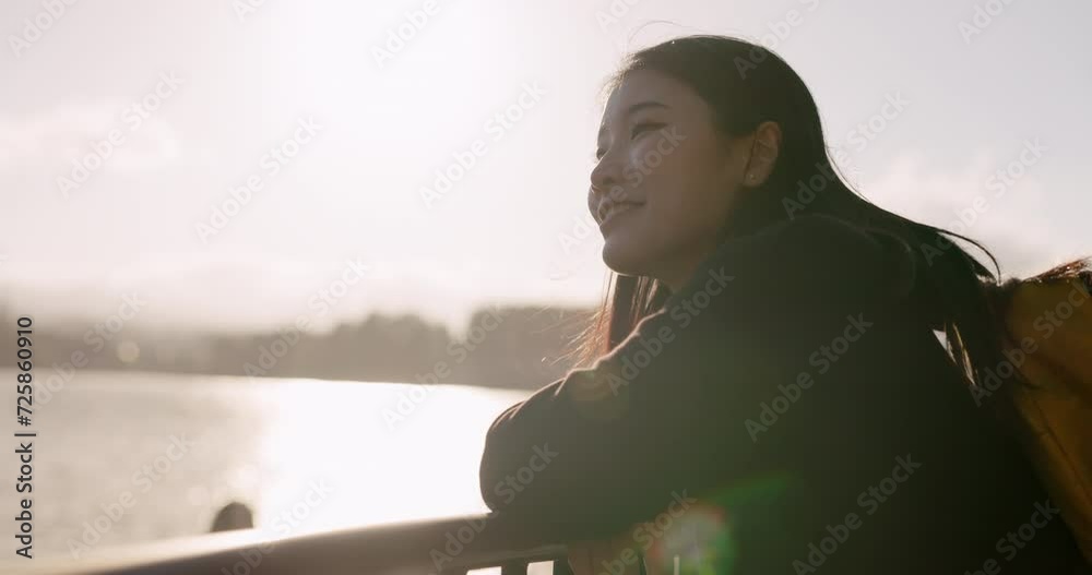 Japanese woman, lake and backpack with thinking, smile and sunrise on adventure, trip or vacation. Girl, person and happy for holiday with bag, vision and memory by water, river and bridge in Tokyo