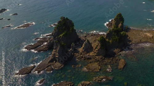 Cinematic aerial shot of Minokake Rock - series of sea stack in Izu peninsula in Shizuoka prefecture, Japan photo