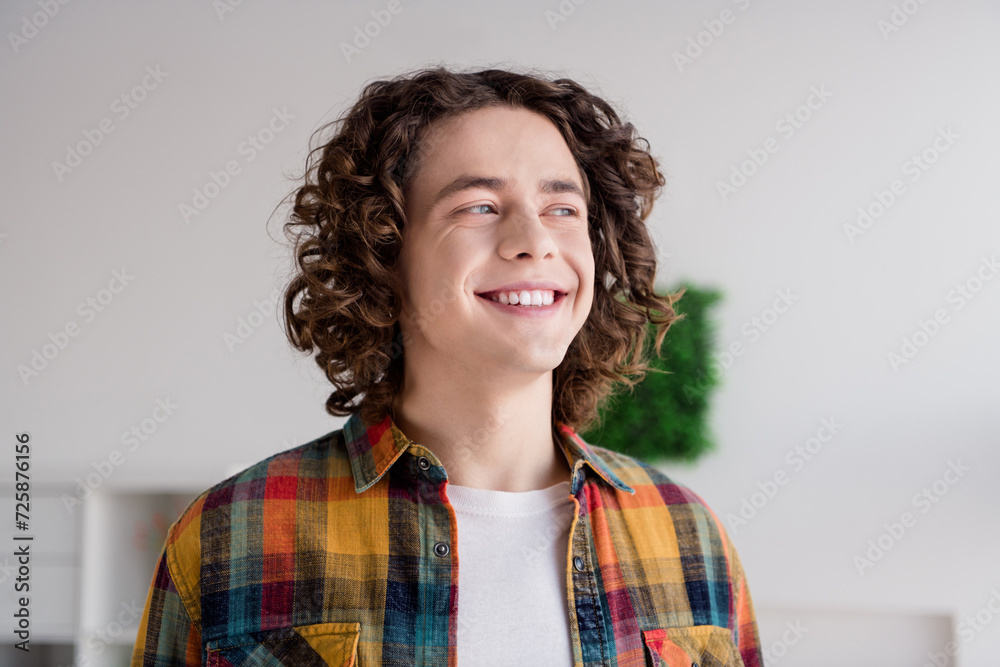 Photo of dreamy good mood guy dressed checkered shirt smiling white teeth dreaming indoors house home room Photo of dreamy good mood guy dressed checkered shirt smiling white teeth dreaming indoors house home room
