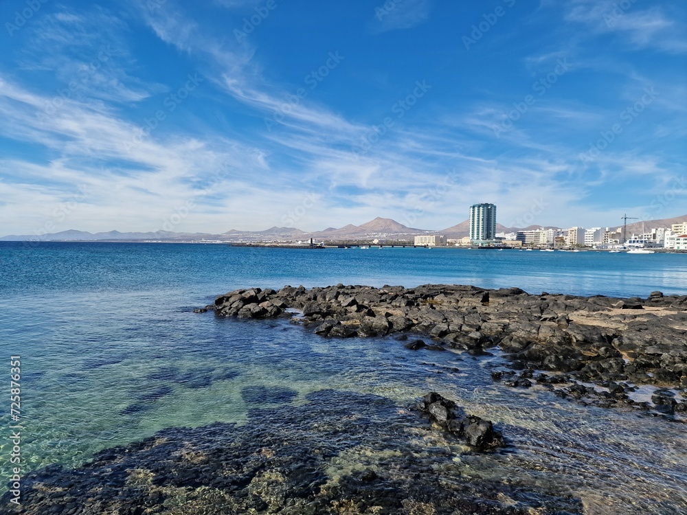 Walking the Arrecife, Lanzarote seaside promenade offers a blend of coastal charm and Canarian architecture. Walking the Arrecife, Lanzarote seaside promenade offers a blend of coastal charm and Canarian architecture.