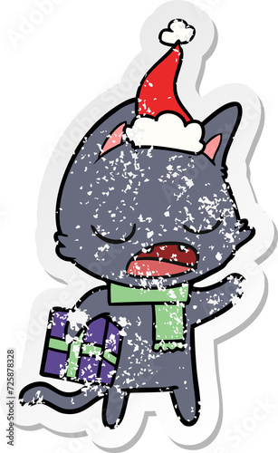 talking cat distressed sticker cartoon of a wearing santa hat
