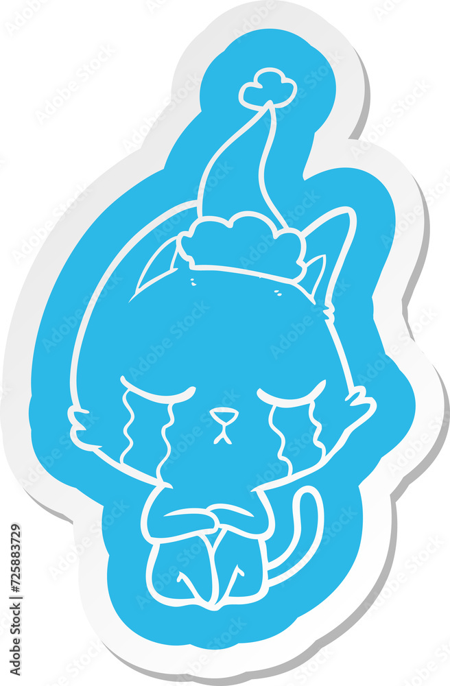 Fototapeta premium crying cartoon sticker of a cat sitting wearing santa hat