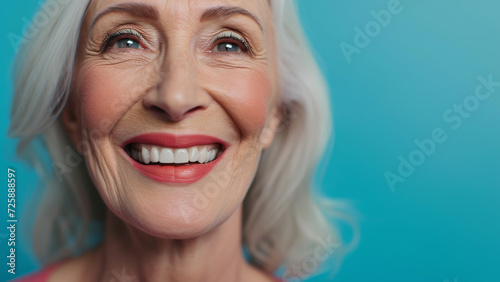 Elderly woman with gray hair is laughing and smiling, mature old lady with healthy face ans skin and white teeth. Portrait of a smiling senior woman