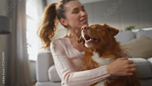 Wallpaper Mural Woman hugging adorable dog with happy smile at home close up. Girl caressing pet Torontodigital.ca