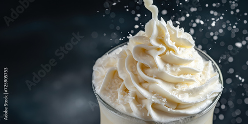 Frothy Milkshake with Whipped Cream, copy space. Exquisite milkshake with a lavish topping of whipped cream.