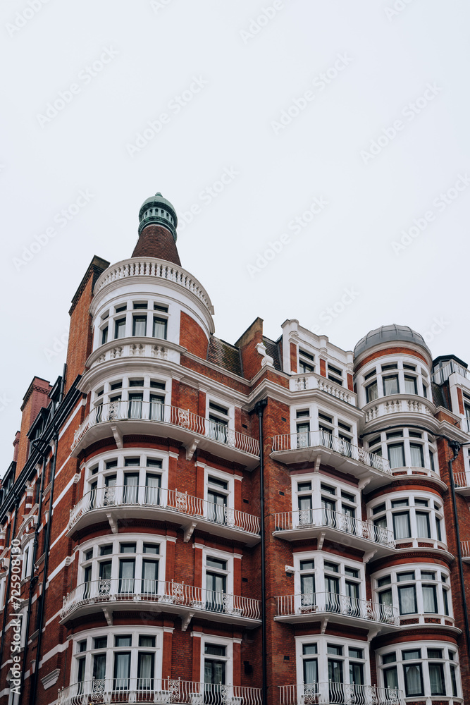 Traditional red brick apartment block in Kensington and Chelsea, London, UK.