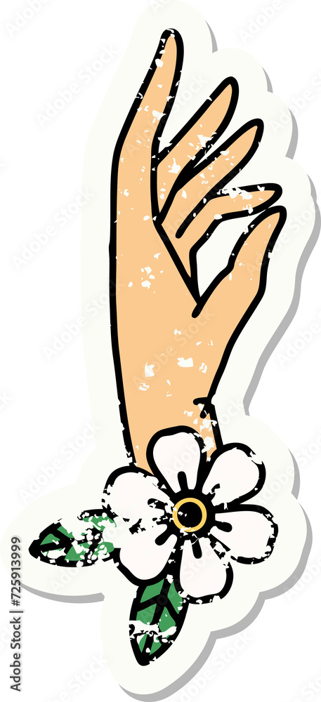 Fototapeta premium traditional distressed sticker tattoo of a hand and flower