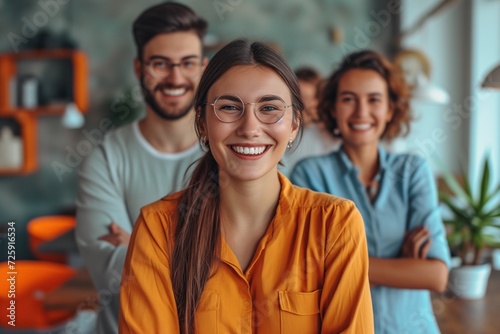 Young Woman leader in a small undertakings office, her diverse and cheerful team behind of her