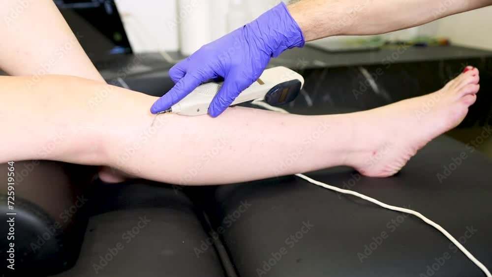 An unrecognizable physical therapist is using an acupuncture-stimulating, punctual search device to relieve pain in a patient's legs. Acupuncture Finder & Stimulator An unrecognizable physical therapist is using an acupuncture-stimulating, punctual search device to relieve pain in a patient's legs. Acupuncture Finder & Stimulator