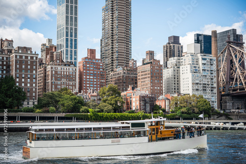 A view of the upper East Side in Manhattan with the boat on East River in the foreground in York City, United States.