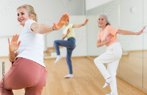 Modern positive active females dancing excited posing in studio