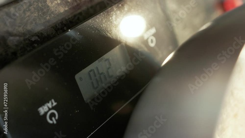 Culinary weighing scale displaying ascending numbers as a chef adds ingredients, capturing precise culinary measurement, vertical video
