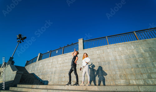 Young couple is walking down the stairs in the city