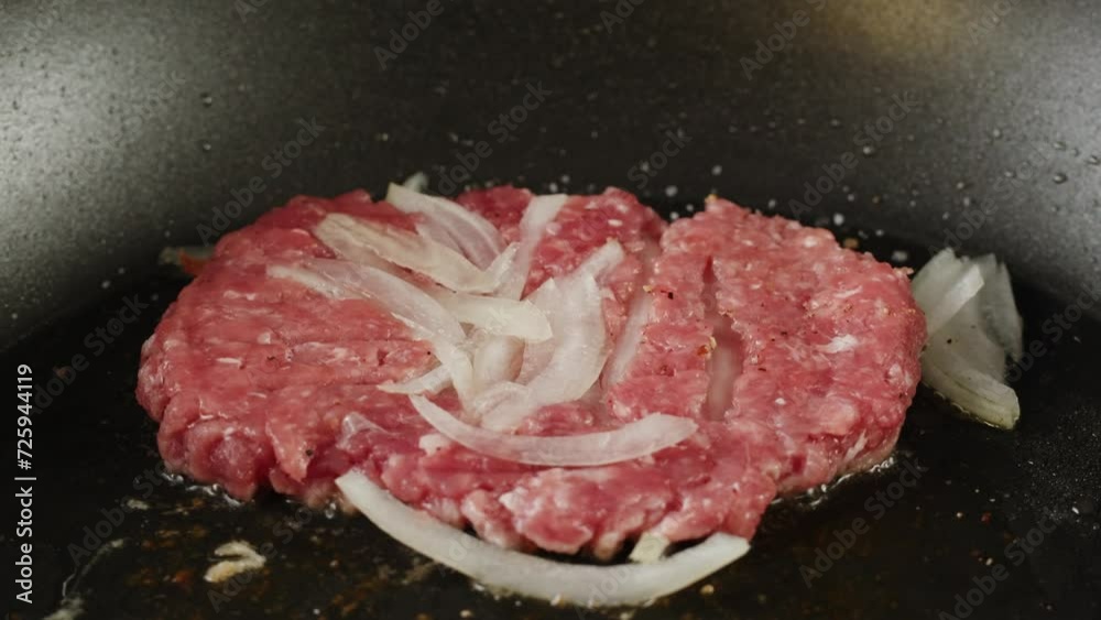 Cooking American fat smash burger with fresh onion on top on grill close-up. Beef or pork cutlet smashing by burger press. The chef in kitchen of the restaurant making cutlets for burgers - smash Cooking American fat smash burger with fresh onion on top on grill close-up. Beef or pork cutlet smashing by burger press. The chef in kitchen of the restaurant making cutlets for burgers - smash