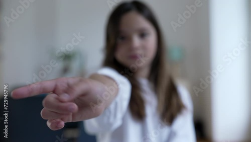 One little girl's hand Shaking Finger In Negation, Child Saying No With Hand by waving NO in disapproval photo