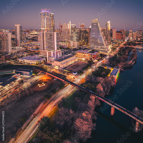 See Austin from above! Bathed in warm hues, its iconic landmarks shine - from the Capitol to Zilker Park. Traffic whispers, the river reflects, and a city hums