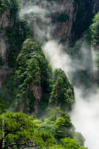 Clouds float amidst the Second Ring Road in the West Sea (Xihai) Grand Canyon of Huangshan Yellow Mountains.