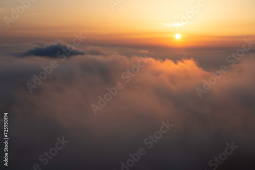 The Sun sets over the Sea of Clouds in the Yellow Mountains of China.