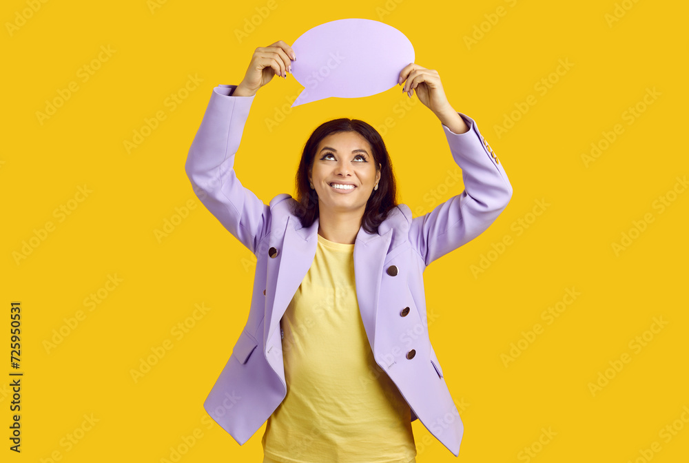 Nice brunette female in jacket holding copy empty blank space paper over head, isolated over vivid yellow background. Inspired young lady having idea. Information, thought, quote and opinion concept. Nice brunette female in jacket holding copy empty blank space paper over head, isolated over vivid yellow background. Inspired young lady having idea. Information, thought, quote and opinion concept.