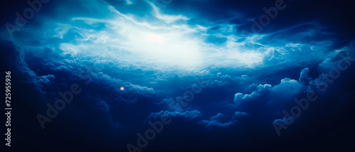 Ethereal clouds with blue light and beams  dark navy  and white hues. Realistic dreamlike horizons  aerial view  high contrast  chiaroscuro. Detail in a captivating  atmospheric shot