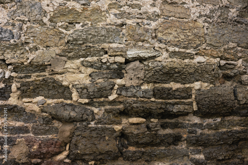 Texture of an ancient weathered stone wall Texture of an ancient weathered stone wall