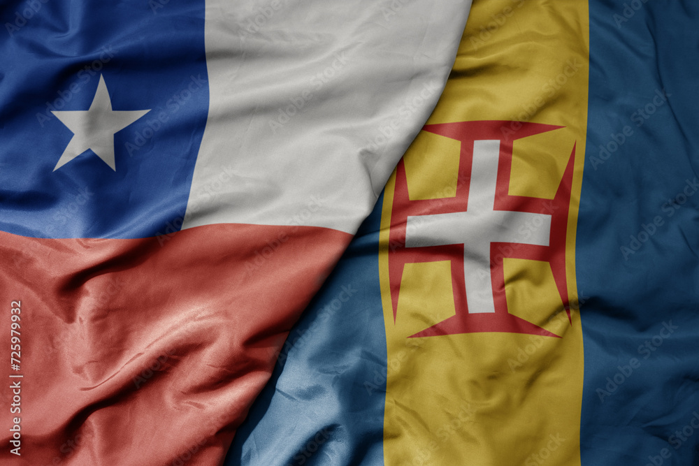 Fototapeta premium big waving national colorful flag of madeira and national flag of chile .