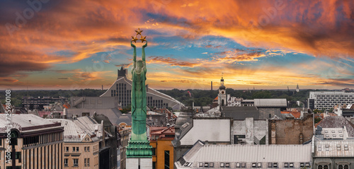 Beautiful sunrise view over Riga by the statue of liberty - Milda in Latvia. The monument of freedom. photo