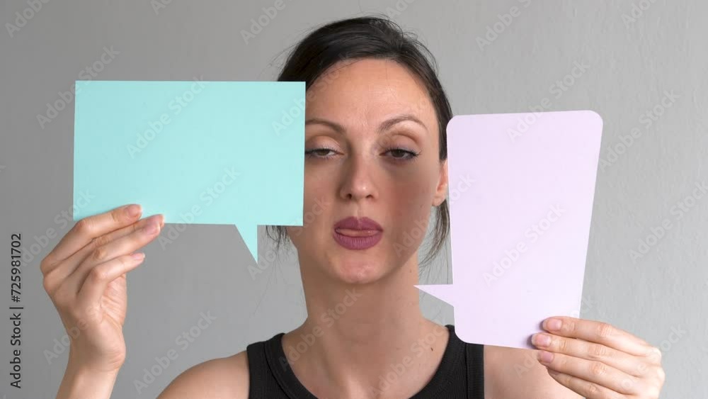 Talkative woman holding up a speech bubbles Talkative woman holding up a speech bubbles