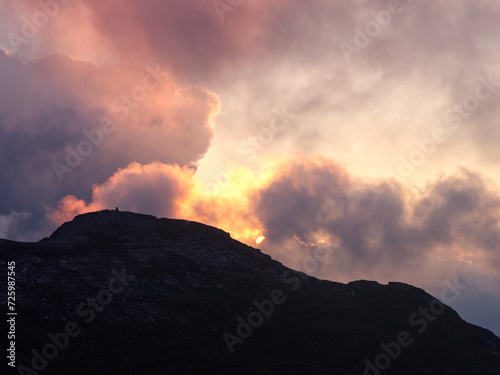Dramatic cloud formation over mountain ridge during sunset 