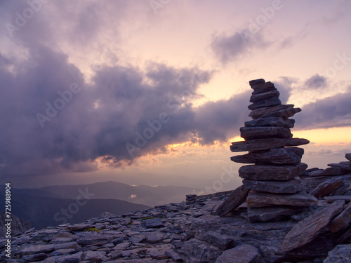 Rocks stacking pyramid with breathtaking sunset view. Mountain Olympus, Greece 