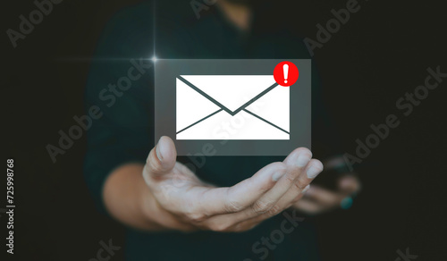 Email alert concept with warning and email notification on hand.